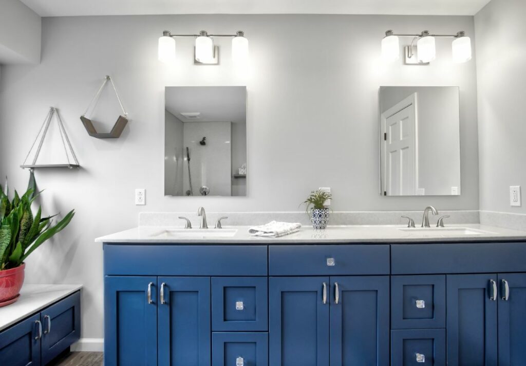 Remodeled master bathroom in St Charles, MO with custom blue vanity cabinetry