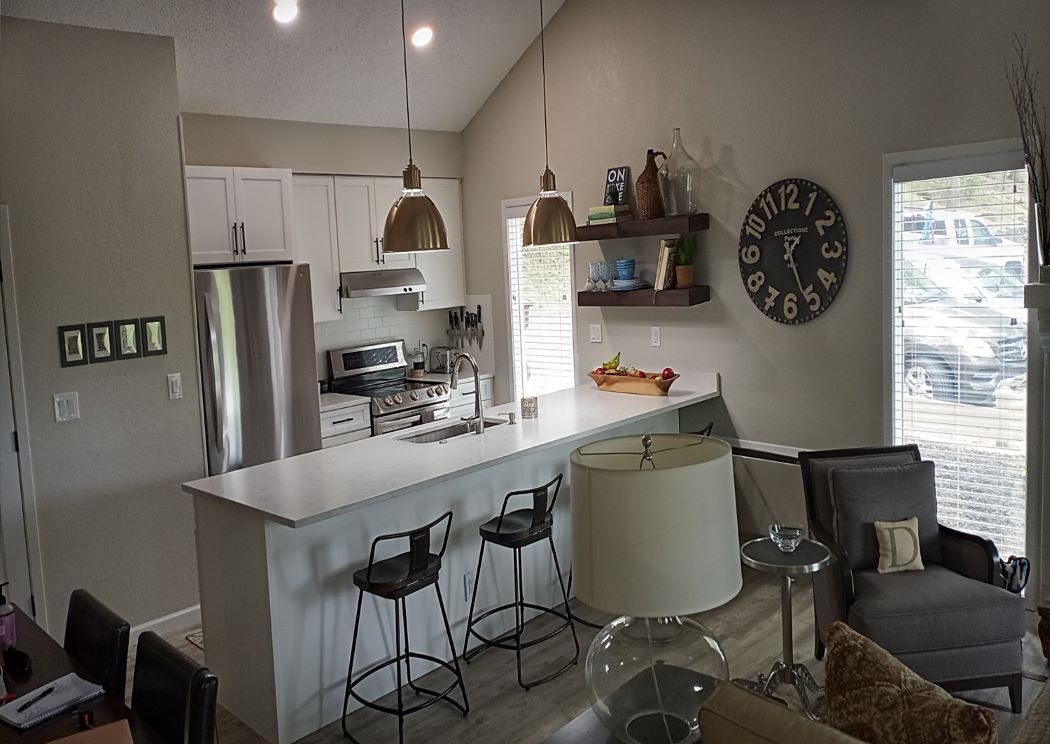 Completed kitchen remodel in Osage Beach, MO featuring white Waypoint cabinets and Cambria quartz countertops