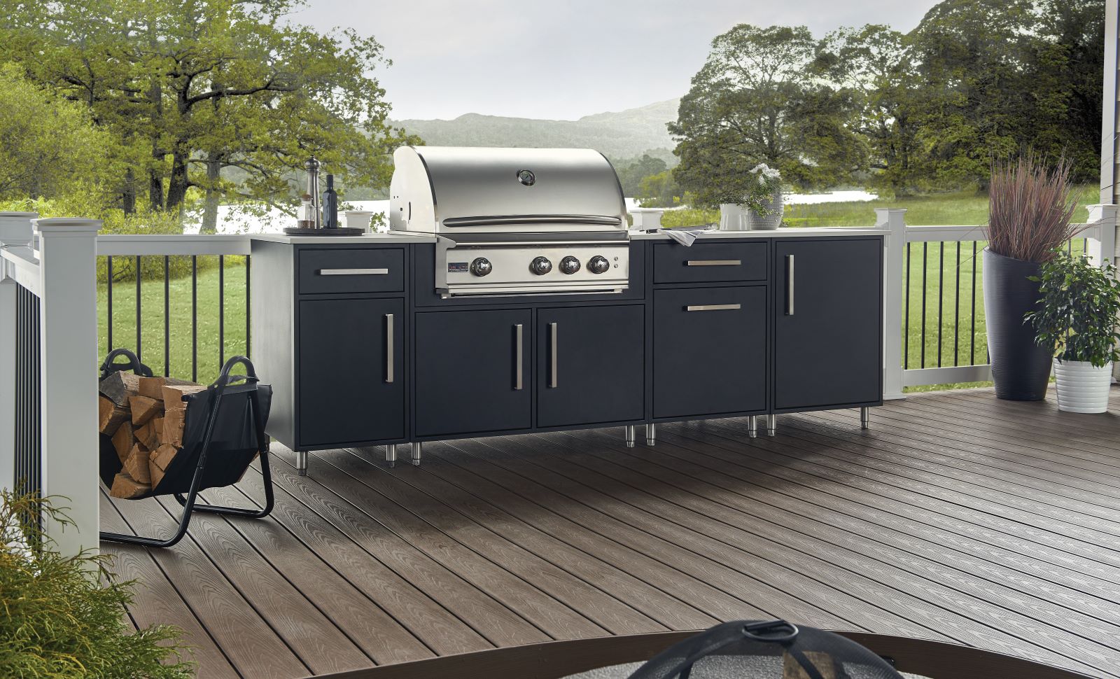 Outdoor kitchen cabinets in flat black door style sitting on deck with lake or water in the background