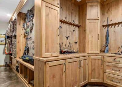 Custom gun room with custom cabinet storage everywhere.