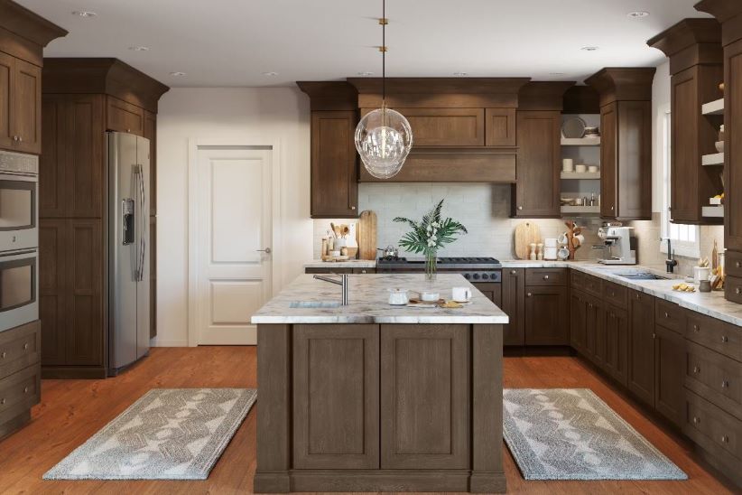 Thompson Price traditional cabinet styles in st louis with dark stain and ornate island and wood hood.