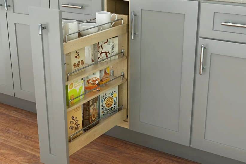 Thompson Price kitchen cabinet organizers showing a pull-out spice rack installed in a narrow full-height base cabinet