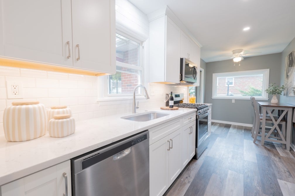 Small kitchen remodel in St Louis, MO by Thompson Price Kitchens, Baths & Home after remodeling was completed. Image shows view of dishwasher, sink and range