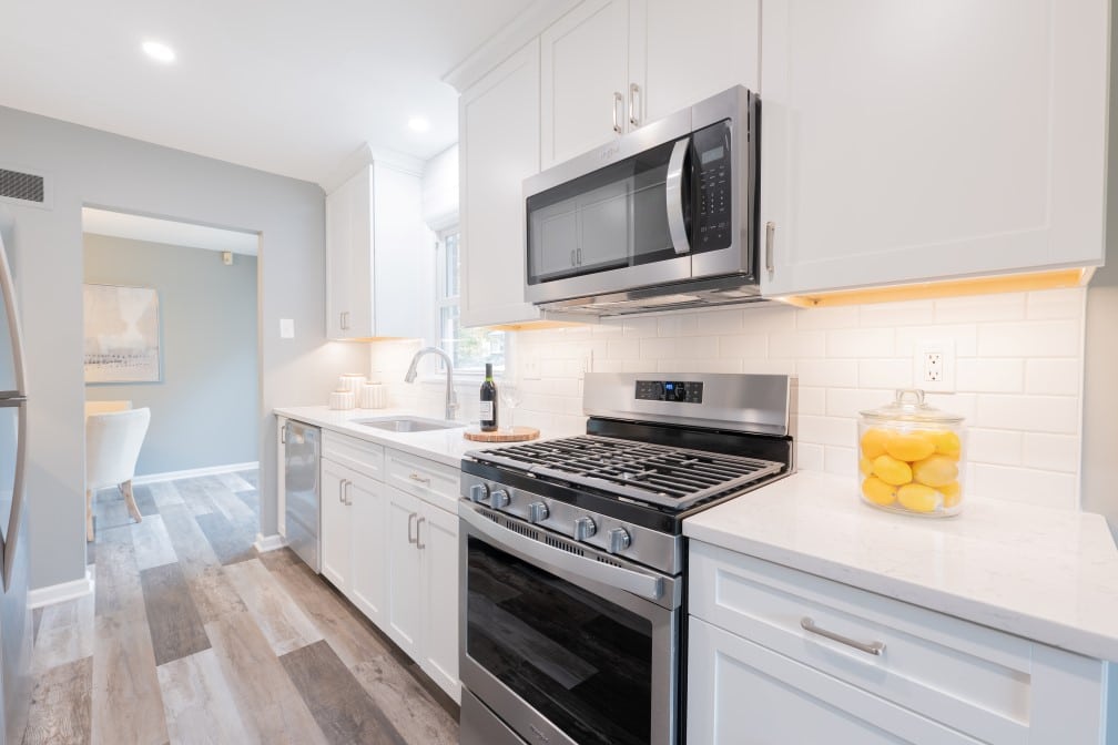 Thompson Price small kitchen remodel st louis, mo after remodel with white cabinets, granite countertops and ceramic tile backsplash