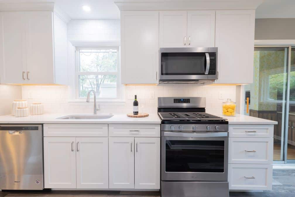 Small kitchen remodel in St Louis, MO by Thompson Price Kitchens, Baths & Home after remodeling was completed. Image shows front on view of sink and range.