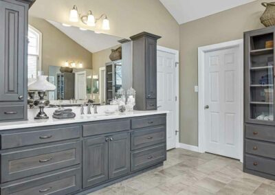 Thompson Price master bathroom remodel in Chesterfield, MO with porcelain floor tile and custom stained bathroom cabinets