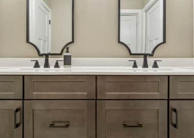 Thompson Price custom bathroom cabinets with double sinks in dark stain