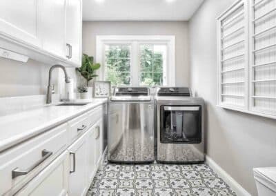 Thompson Price laundry room remodel with custom cabinets, quartz countertops and deco tile in Chesterfield, MO