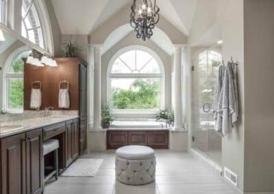 Thompson Price large master bathroom remodel with custom stained bathroom cabinets, drop-in tub and chandelier.