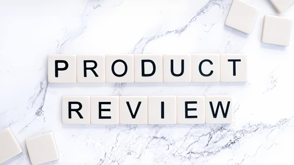 Thompson Price product reviews spelled out in scrabble letters over marble countertop background