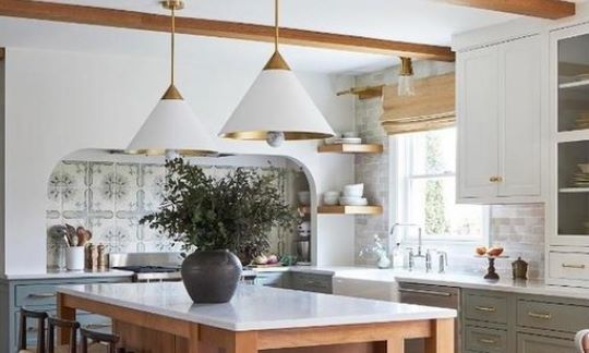 Thompson Price kitchen remodeling in St Louis showing kitchen pendant lighting with white shades and brass trim