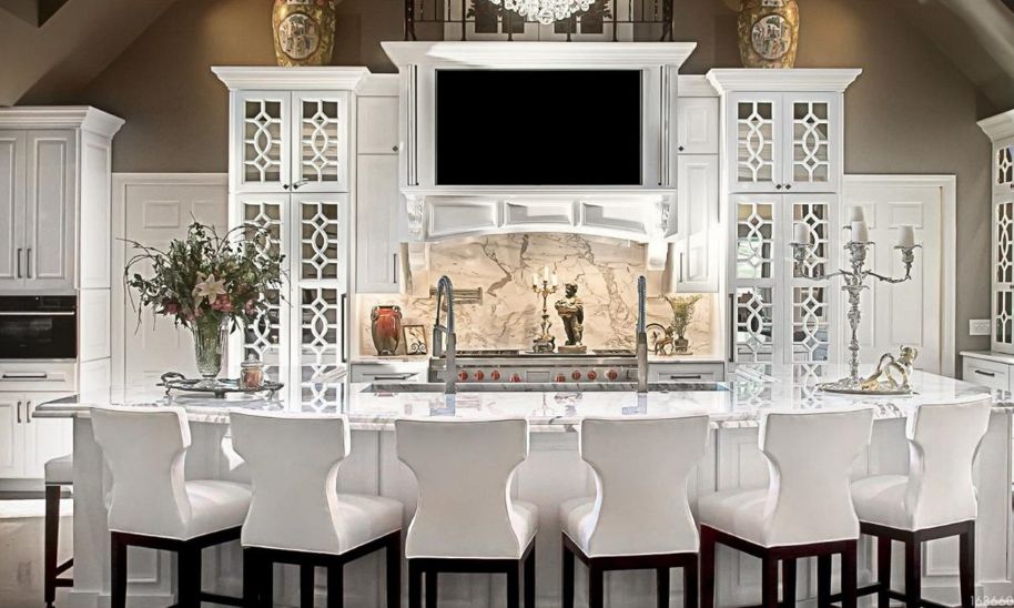 Kitchen with white custom cabinets with mirror mullion doors in full overlay