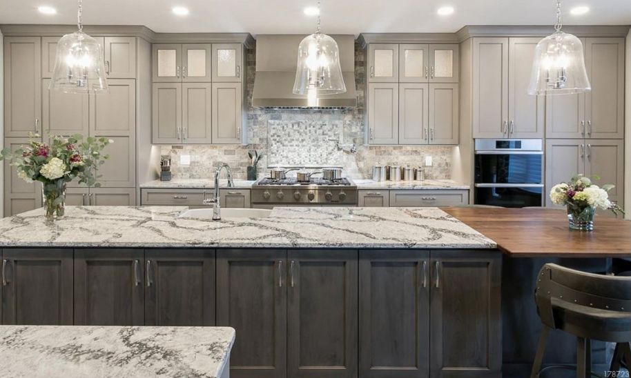 Kitchen with custom light cabinets on back wall and dark stained island in marginal overlay