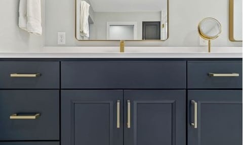 Bathroom remodel with custom bathroom cabinets in painted blue with white quartz countertop