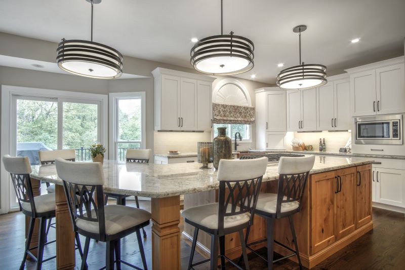 View of seating area with stools at island in kitchen remodel West St Louis County