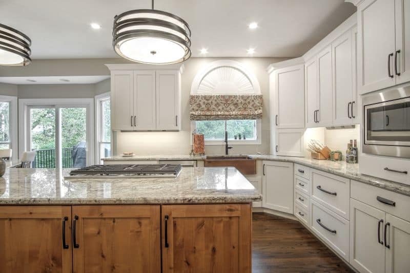 Back view of island with kitchen window and copper sink in background