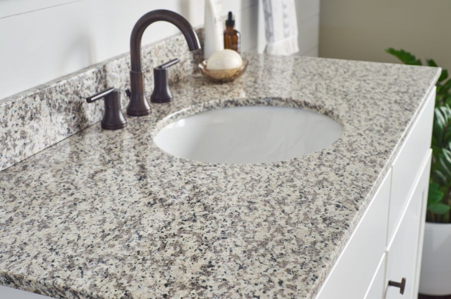 natural granite vanity countertop in tiger skin pattern with oval vanity sink bowl and faucet in oil rubbed bronze finish