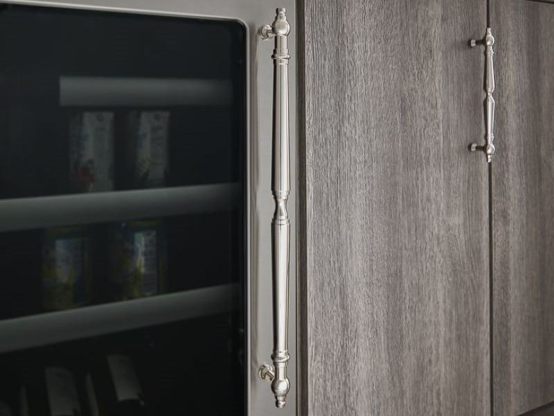 Appliance pull in polished chrome on paneled under-counter refrigerator