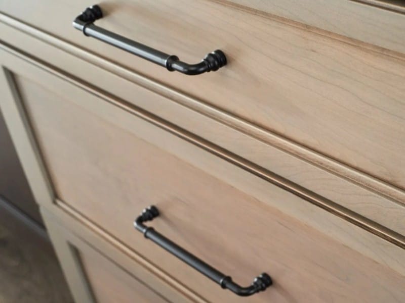 Thompson Price kitchen cabinet hardware in matte black on light stained cabinetry