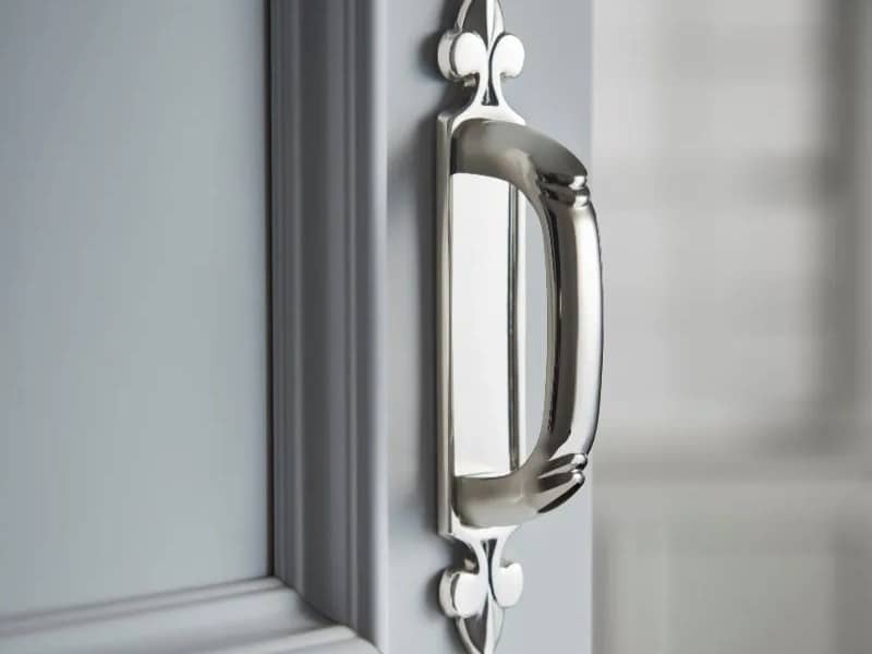 Kitchen cabinet door pull in polished nickel finish with backplate and traditional design