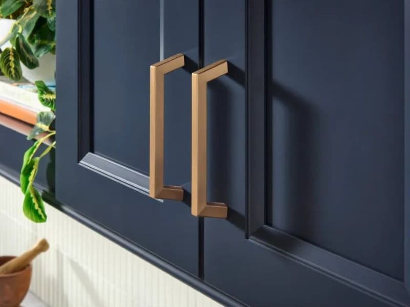 Ivan Kitchen cabinet pulls in brushed satin finish against dark blue painted cabinet doors