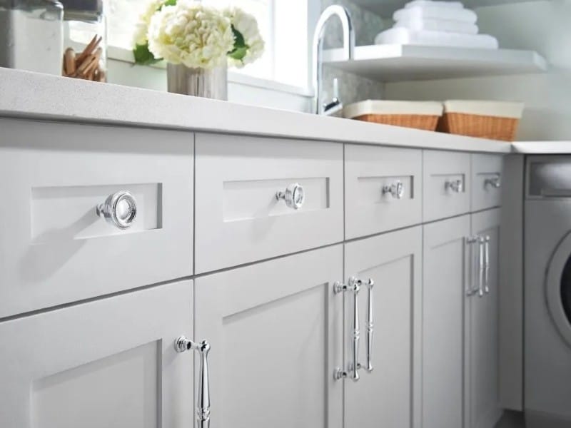 Kitchen cabinet hardware in polished chrome with knobs on drawers and pulls on doors